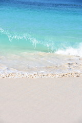 Sandy tropical beach and blue turquoise ocean water