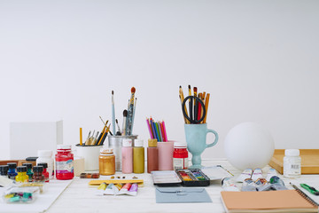 Artist studio with paper and utensils. Workspace of designer illustrator with gypsum shapes,...