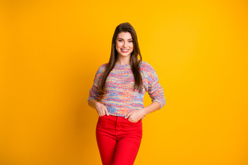Obraz premium Portrait of content candid pretty girl enjoy spring holidays weekends put hands pocket wear modern pullover clothes isolated over vivid color background