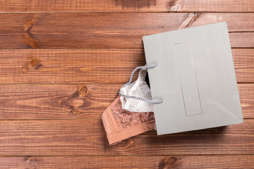 Bra and panties in a gift bag. Copy space. Flat lay. The concept of clothing, accessories, shopping, lingerie.