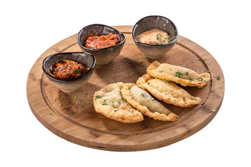 Traditional meat pie cheburek with different deep fried on wooden board isolated on white background