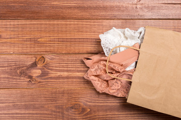 Bra and panties in a gift bag. Copy space. Flat lay. The concept of clothing, accessories, shopping, lingerie.