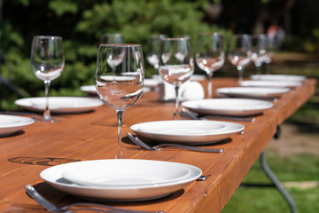 Served wooden table without a tablecloth. Cafe in the open air park