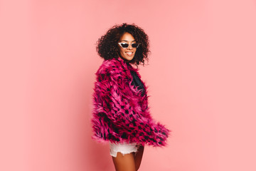 Black woman in a black faux fur jacket, Close up fashion portrait of crazy hipster African girl...