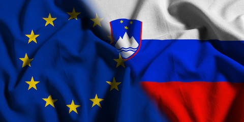 National flag of Slovenia with European Union (EU) flag on a waving cotton texture background