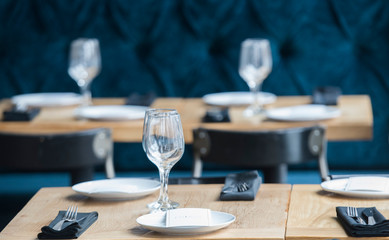 wine glasses and utensils are shown on a table at a restaurant