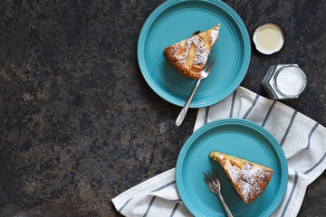 Charlotte - a classic pie with apples on a concrete background.