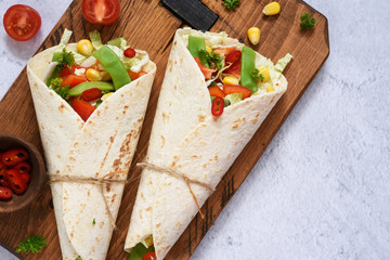 Tortilla with vegetable filling with chili pepper and sauce.