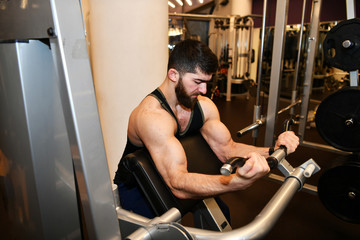 male athlete engaged in physical exercises in the gym