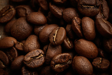  Whole brown coffee grains close-up. The aroma of coffee, selected grains, arabica, vigor, relaxation, pleasure.