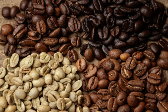  Four types of coffee beans of different roast top view. The aroma of coffee, selected beans, arabica, energy, relaxation, pleasure