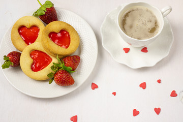 Homemade Cookies with a strawberry Jam Heart and a cup