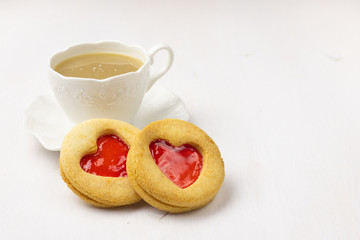 Homemade Cookies with a strawberry Jam Heart and a cup