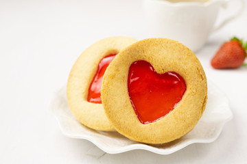 Homemade Cookies with a strawberry Jam Heart and a cup