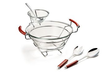 An empty large main glass bowl, for salad or appetizers, that have a smaller glass bowl which attaches to the rim, giving an extra space for dips and sauces. Isolated on a white background.