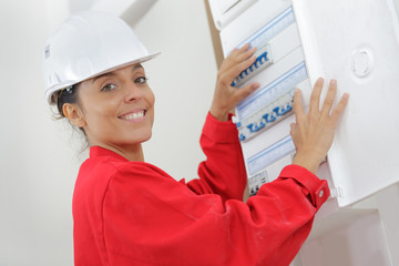 female electrician installing energy saving meter