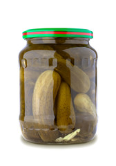 A glass jar of tasties canned cucumbers on white background. 