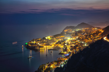 Aerial panoramic view of the old town of Dubrovnik in beautiful evening twilight at dusk.