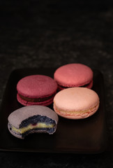 Colorfull macarons black background. Pink color macaroons.