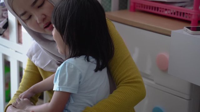 daughter comfort by muslim mother when crying having tantrum