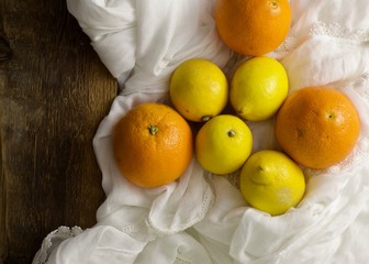 A bunch of citrus fruit on a white fabric