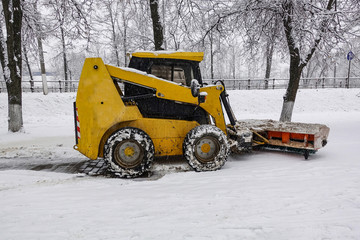 A small snowplow for snow removal in the city. Russia.