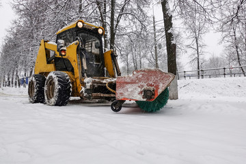 A small snowplow for snow removal in the city. Russia.