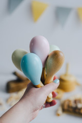 The girl holds in her hand several maracas made of natural wood.