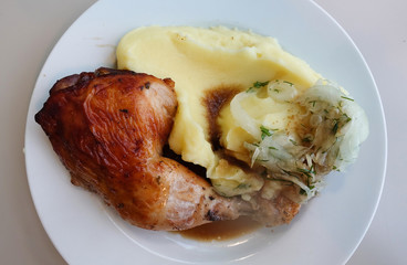 A piece of fried chicken with mashed potatoes. Hearty meal.