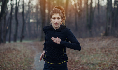 Young athlete exercise at the park. Young woman running at the park