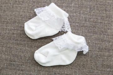 Newborn's legs are small in the hands of parents