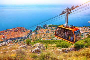 Aerial panoramic view of the old town of Dubrovnik with famous Cable Car on Srd mountain on a sunny day. © pilat666