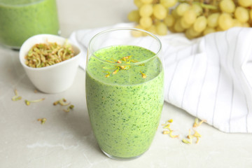 Green buckwheat smoothie on light grey marble table