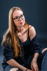 Portrait of an attractive young blonde woman in glasses