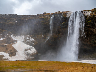 Fantastic waterfall in Iceland, winter tourism,
