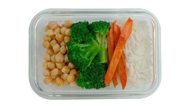 Vegan dish: rice, chickpeas and broccoli. Office lunch in a container on a white background. The concept of proper nutrition.