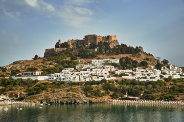 Fototapeta na wymiar Medieval fortress and white houses of Lindos village in Rhodes.