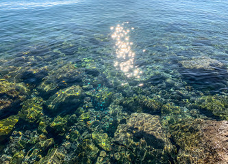 Sun glare on the sea surface, natural colors of the sea water, background