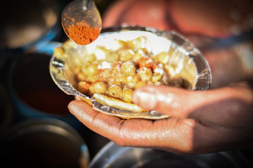 hands holding bowl of Indian cereal, Indian Tikki