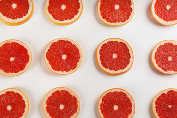 Fototapeta na wymiar Flat lay composition with tasty ripe grapefruit slices on white background