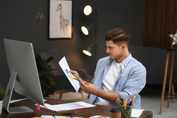 Male designer working at desk in office