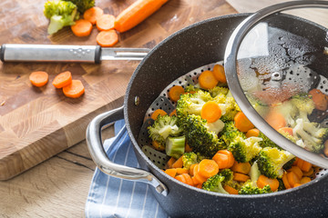 Steamed mixed vegetable in black pot. Healthy vegetable concept