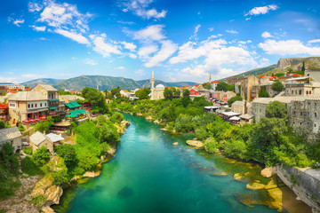 Fototapeta na wymiar Nerteva River and Old City of Mostar, with Ottoman Mosque during sunny day