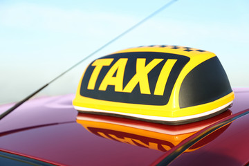 Roof light with word TAXI on car outdoors