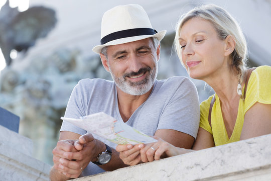 Traveling Couple Searching On The Map