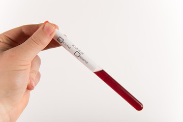 Illustration of hand with gloves holding test-tube with corona virus ncov blood.