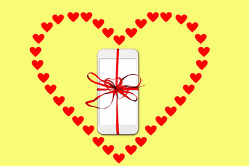 Valentine day, Christmas gift concept, on yellow background isolated heart shape from red paper hearts and smartphone with red ribbon