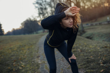 Young athlete exercise at the park. Young woman running at the park