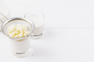 Homemade fermented beverage kefir with kefir grains in bowl on a white background, concept of natural fermented food and gut health