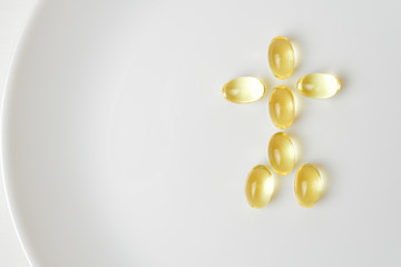 Fish oil capsules on a plate